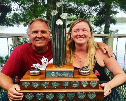 Chelsea Carey with her father and awards