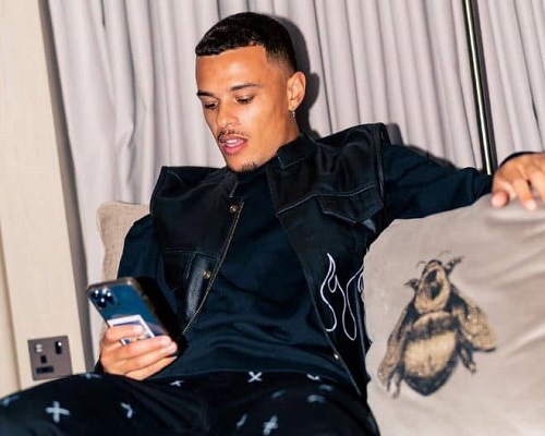 Joel Latibeaudiere with his iphone